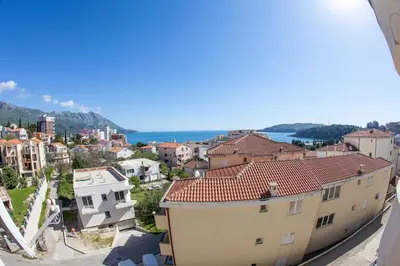 a view of a city with buildings and the ocean at Apartments Charme in Becici