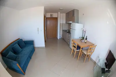 a living room with a blue couch and a table at Apartments Charme in Becici