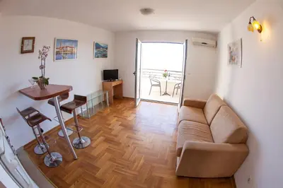 a living room with a couch and a table at Apartments Charme in Becici