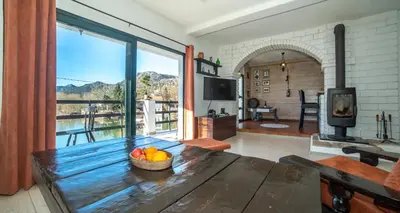 a living room with a table with a bowl of fruit on it at Lux Apartment Sunset in Virpazar