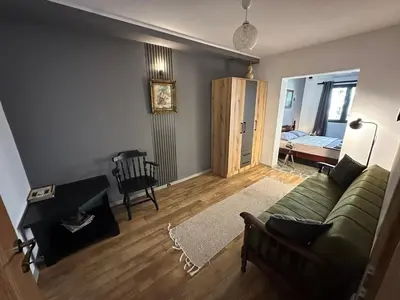 a living room with a green couch and a table at Lux Apartment Sunset in Virpazar