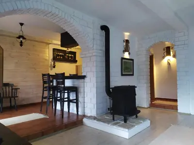 a fireplace in a room with a table and chairs at Lux Apartment Sunset in Virpazar
