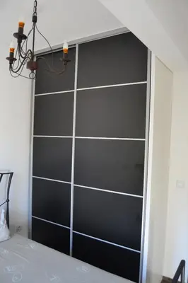 a black book shelf in a room with a bed at Old Town View Apartment in Budva