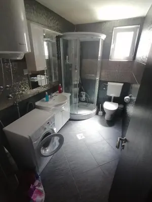 a bathroom with a shower and a toilet and a sink at Old Town View Apartment in Budva