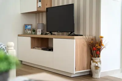 a tv on a cabinet in a living room at Apartments Gruda in Cetinje