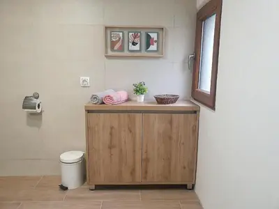 a bathroom with a toilet and a wooden cabinet at Apartments Gruda in Cetinje