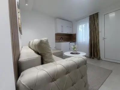 a living room with a couch and a table at Apartments Doha in Ulcinj