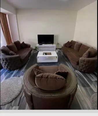 a living room with two couches and a table at Apartman Jovicevic Pavle in Rijeka Crnojevića