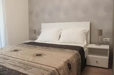 a bedroom with a large bed with two night stands at Apartment Golubović Kotor in Kotor