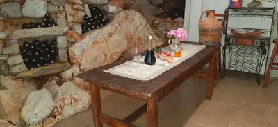 a wooden table with a bunch of wine bottles on it at Blue Mediterranean Apartments in Sveti Stefan