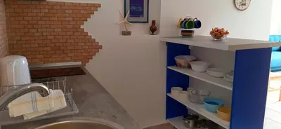 a kitchen with a sink and a brick wall at Blue Mediterranean Apartments in Sveti Stefan