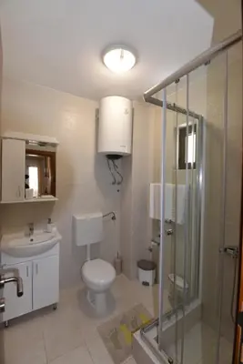 a bathroom with a toilet and a sink and a shower at Studio Apartments 6 Palmi in Budva