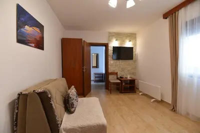 a living room with a couch and a table at Studio Apartments 6 Palmi in Budva