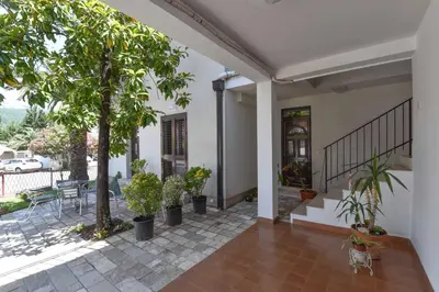 a porch of a house with trees and plants at Studio Apartments 6 Palmi in Budva