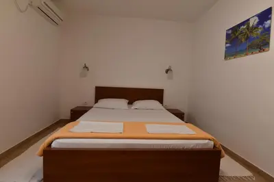 a bedroom with a large bed in a room at Studio Apartments 6 Palmi in Budva