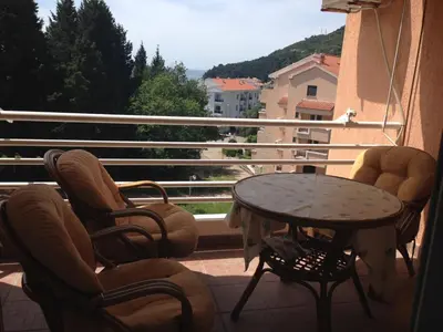 a balcony with chairs and a table and a view at Home Apartment Petrovac in Petrovac na Moru