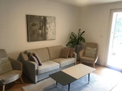 a living room with a couch and two chairs at Home Apartment Petrovac in Petrovac na Moru