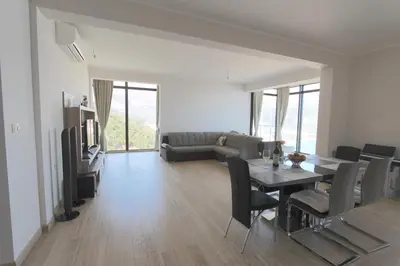 a living room with a table and chairs and a couch at Apartments Aqua in Budva