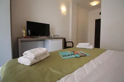 a bedroom with a bed with towels on it at Le Marc Guest house in Budva
