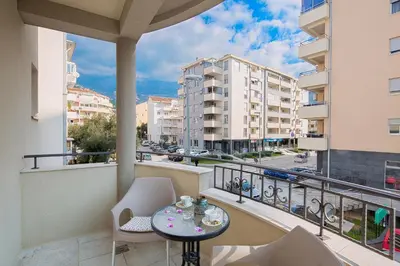 a balcony with a table and chairs and a view of a city at Le Marc Guest house in Budva