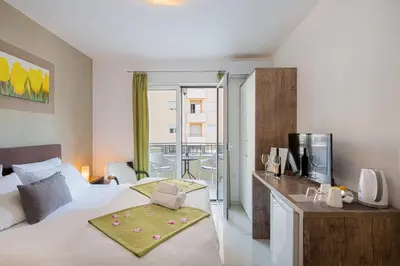 a bedroom with a large bed and a balcony at Le Marc Guest house in Budva