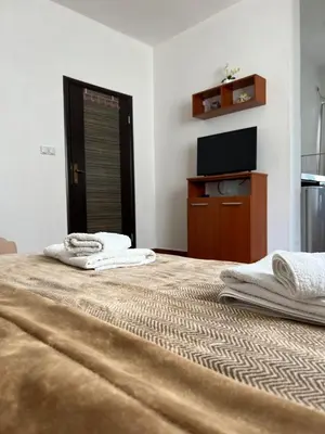 a large bed with two towels on top of it at Apartments Fat e Jet - Pool & Breakfast in Ulcinj