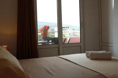 a bedroom with a bed and a window with a view at Apartments Fat e Jet - Pool & Breakfast in Ulcinj