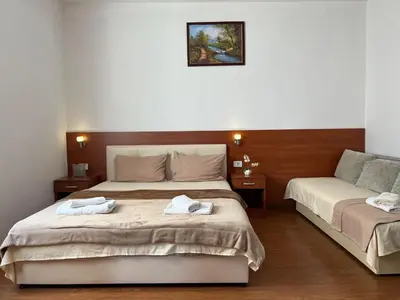 a bedroom with two beds with towels on them at Apartments Fat e Jet - Pool & Breakfast in Ulcinj