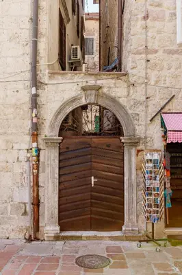 a large wooden garage door in a building at Old Town Museum Square Apartment in Kotor