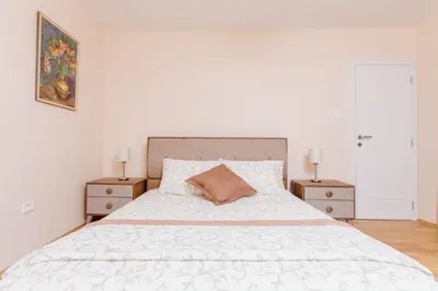 a bedroom with a large bed with two night stands at Old Town Museum Square Apartment in Kotor