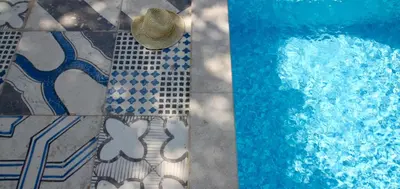 a straw hat is sitting next to a swimming pool at Villa Mima in Kotor