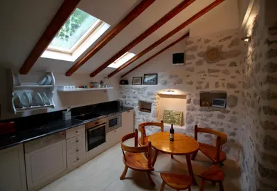 a kitchen with a table and chairs and a window at Villa Mima in Kotor