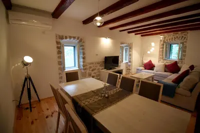 a living room with a table and a couch at Villa Mima in Kotor