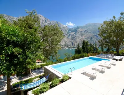 a swimming pool with a view of a lake and mountains at Villa Mima in Kotor