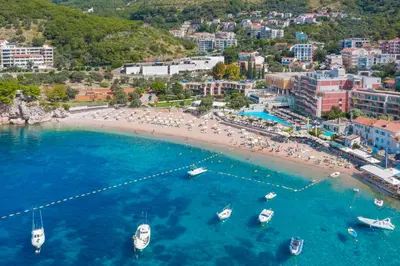 an aerial view of a beach with boats in the water at Vujanović Apartments in Sveti Stefan