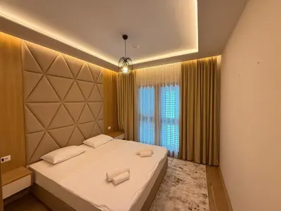 a bedroom with a bed with two towels on it at Vujanović Apartments in Sveti Stefan