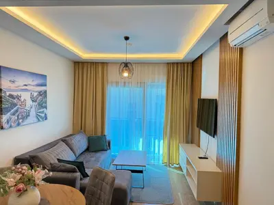 a living room with a couch and a table at Vujanović Apartments in Sveti Stefan