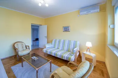 a living room with a couch and chairs and a table at Apartman Kotor in Kotor
