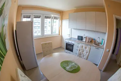 a kitchen with a table and a kitchen with a refrigerator at Apartman Kotor in Kotor