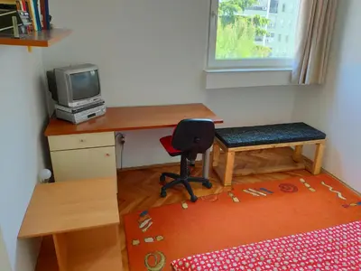 a small room with a desk and a chair and a television at Apartman La Siesta in Bar