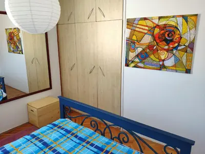 a bedroom with a bed and a painting on the wall at Apartman La Siesta in Bar