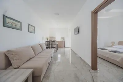 a living room with a couch and a table at Apartmani Agape in Petrovac na Moru