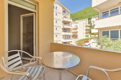 a patio with a table and chairs on a balcony at Apartmani Agape in Petrovac na Moru