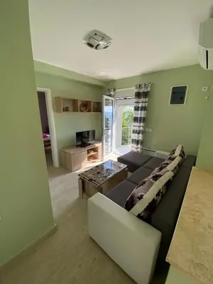 a living room with a couch and a table at Apartments Klikovac Liman II in Ulcinj
