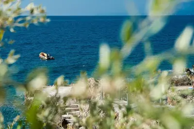 a body of water with a boat in the water at Apartments Limunada in Utjeha