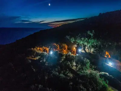 an aerial view of a house on a hill at night at Holiday Park Olive Tree in Ulcinj