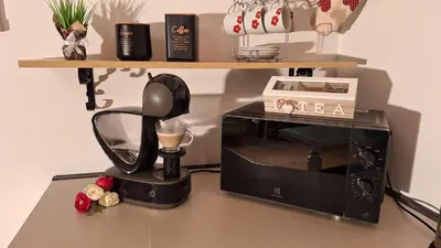 a black blender sitting next to a microwave at Apartments Peranovic 2 in Kotor