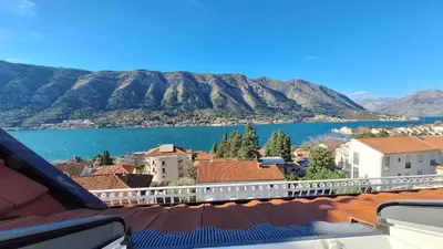 a view of a town with a lake and mountains at Apartments Peranovic 2 in Kotor
