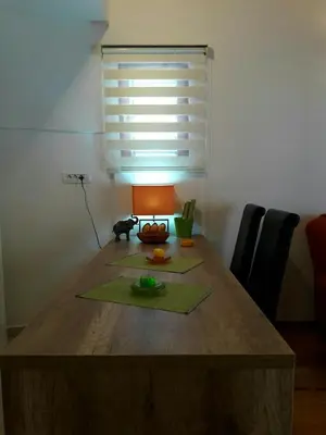 a wooden table with a lamp on top of it at Apartment Maja in Budva