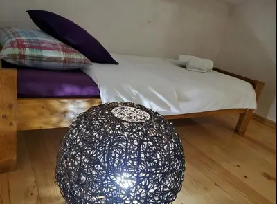 a bedroom with a bed and a black and white ball on the floor at Apartment Maja in Budva